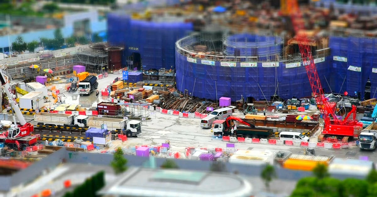 Large construction site with cranes and scaffolding seen from above