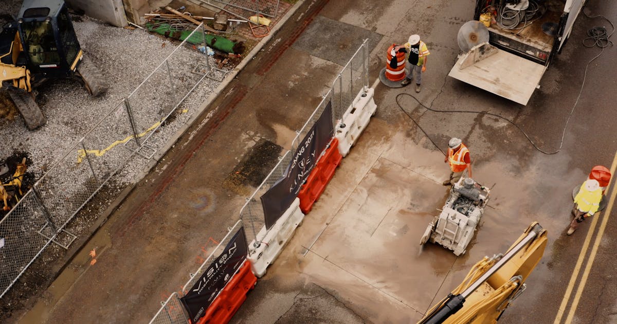 Overhead view of a work site with a crew, safety barriers and equipment