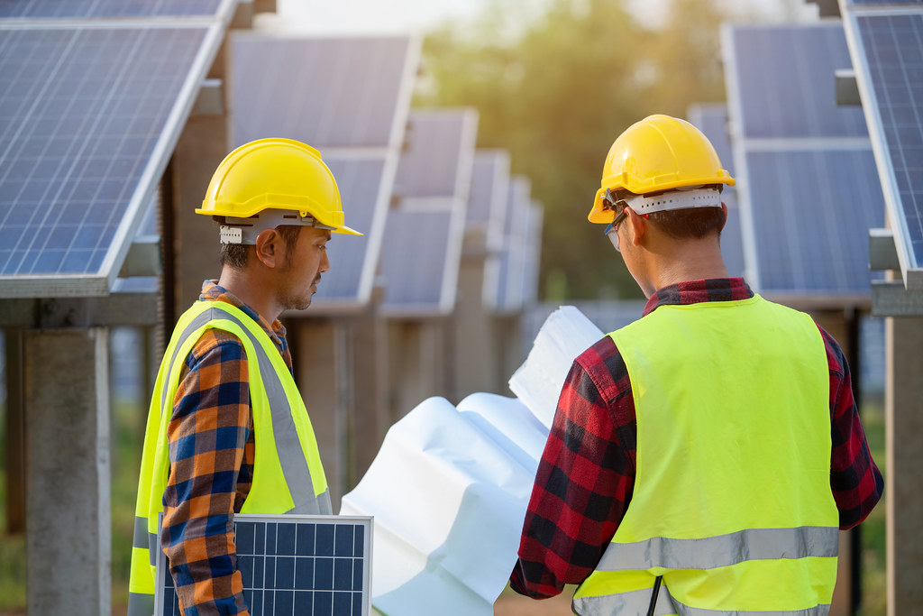 Professional roofing contractor team working safely on project